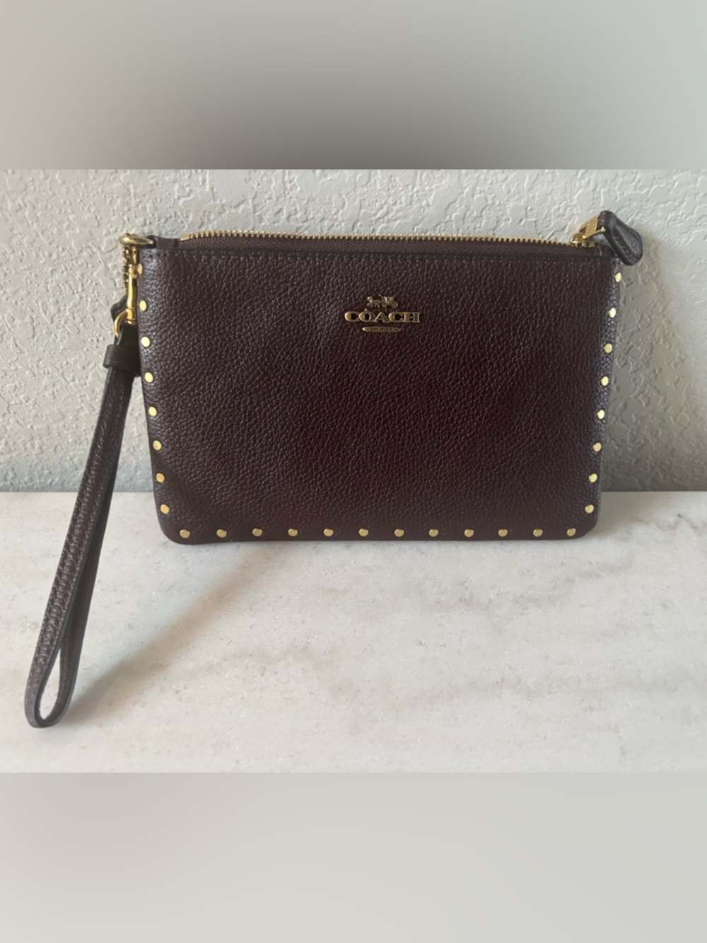 Coach Pebbled Leather Wristlet in Burgundy with Gold Accents